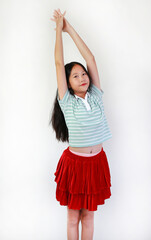 Portrait cheerful of young Asian girl in striped green shirt and a vibrant red tiered skirt...