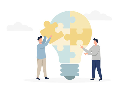 Two businessmen assembling light bulb puzzle pieces for creative idea concept
