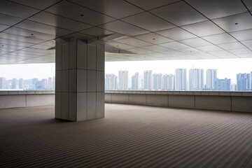 Naklejka premium Looking out at urban buildings from a platform with columns