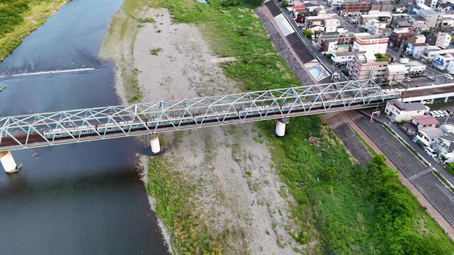 Japanese commuter train on a bridge.  