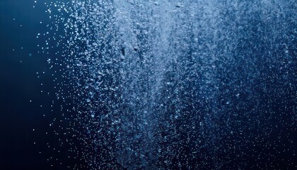 Bubbles rising in deep blue water creating a mesmerizing effect.