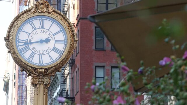 New York City Manhattan Midtown, United States of America. Street Clock on Broadway in Flatiron district near Madison Square Park. 5 fifth avenue Nomad area. Iconic golden clock, vintage clock face.