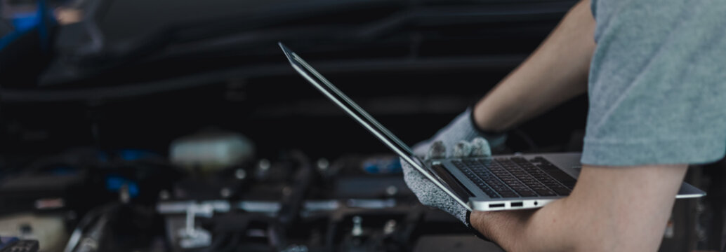 Close-up of a car diagnostic system in use, as a skilled mechanic carefully inspects engine data to provide precise maintenance and reliable repair services in a professional auto repair garage