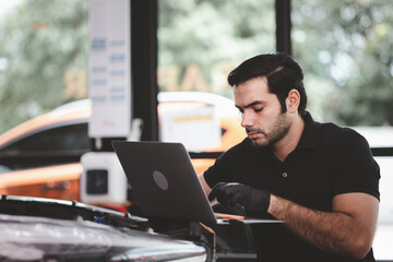 Professional mechanic holding the tablet for maintenance checklist vehicle, Software for manager...