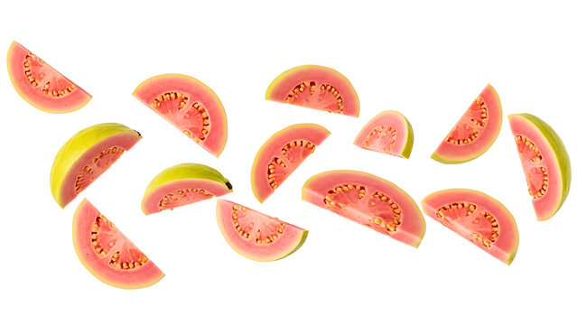 Multiple slices of fresh guava fruit are seen falling in mid air, showcasing their vibrant pink color and black seeds against a clean white background.