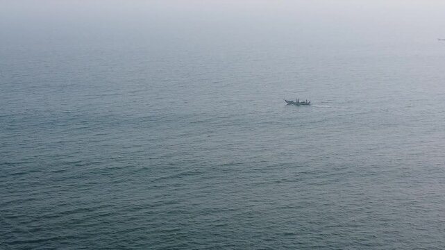 29.12.2025. Puri Orissa India aerial video clip of a lonely boat sailing through the  deep bluish sea water in India