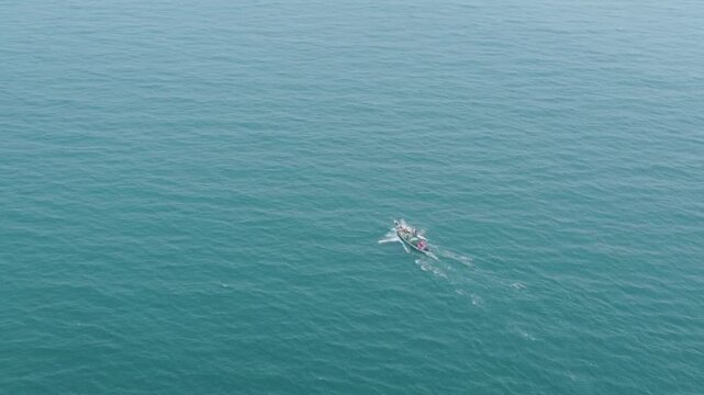 29.12.2025. Puri Orissa India aerial video clip of a lonely boat sailing through the  deep bluish sea water in India