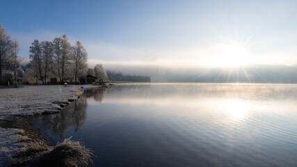 Frosty Sunrise over Weissensee in Bavaria Allgaeu Germany with great sunny Winter Vibes. High quality photo
