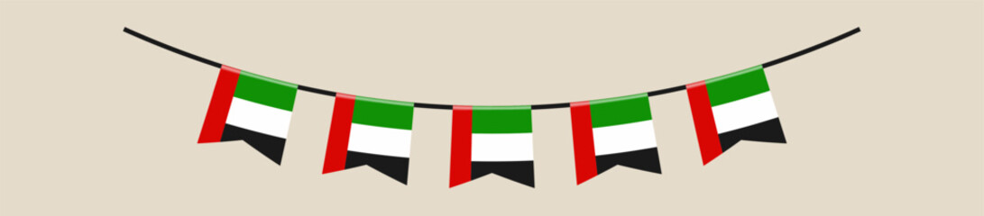 Fototapeta premium United Arab Emirates flag bunting hanging in a garland for a patriotic National Day celebration decorative element.