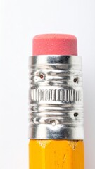 Obraz premium Macro Detail of Classic Yellow Pencil Eraser and Metal Ferrule on White Background