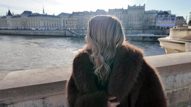 A couple in Paris are taking selfies on a bridge over the Seine River The city buildings are in the background on a sunny day The video is shot handheld from a POV perspective showing candid moments o