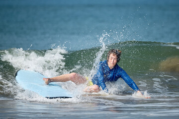 young man jumping into the water