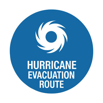 A blue circular sign indicating a hurricane evacuation route with a white hurricane symbol.