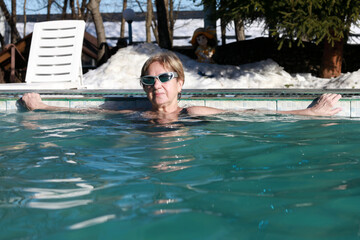Woman relaxing in thermal water pool in Labinsk