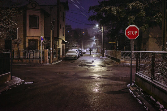 Walking down the street in bad weather with snow