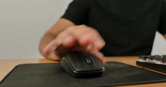 Close-up of man using wireless mouse and mechanical keyboard on desk