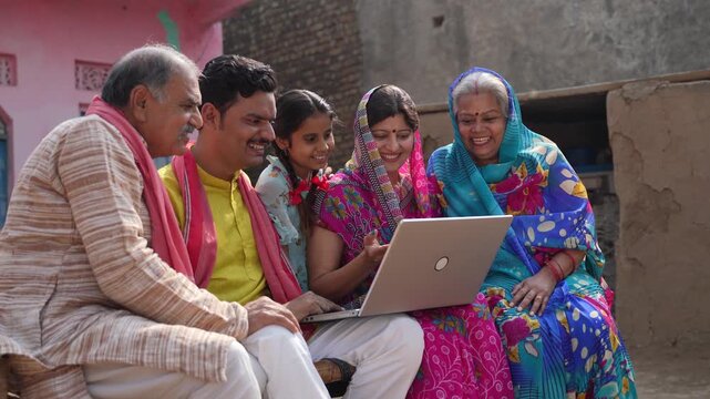 indian farmer family using laptop 