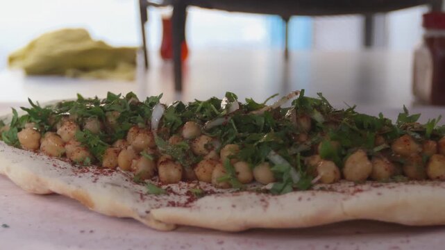 Squeezing fresh lemon juice on a traditional Turkish chickpea wrap (Nohut Durum)