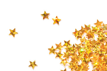 Scattered gold star confetti on white background, shiny celebration decor for festive occasions.