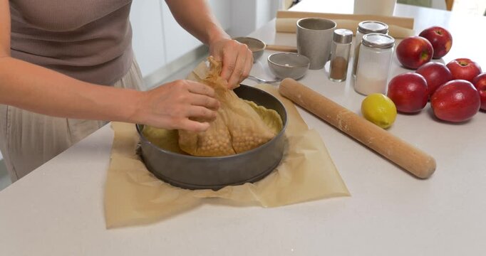 Woman forming shortbread dough in springform pan