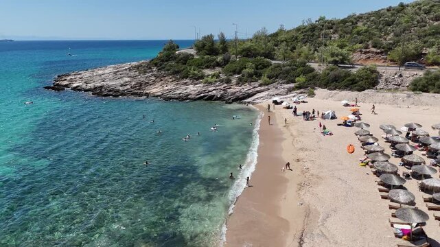 Vertical video of a small sandy beach and turquoise sea