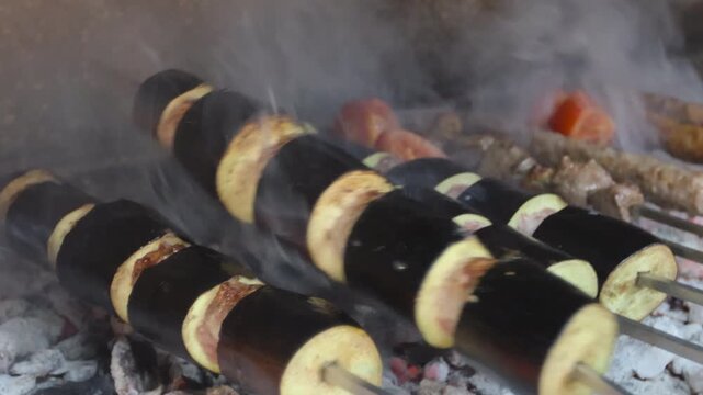 Close up of traditional Turkish eggplant kebab (Patlican Kebabi) grilling over charcoal