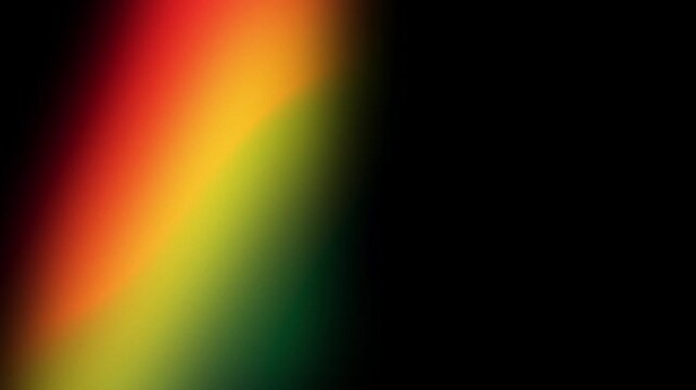 Red, yellow, and green blurred light moving through a black frame. Abstract background for black history month.