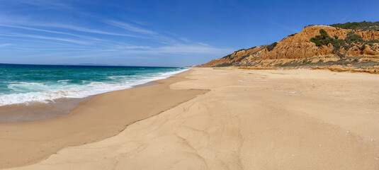  beautiful large and empty beach in the Atlantic Ocean with cliffs  background Medides beach in Portugal © coco