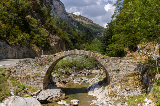 Old stone arch bridge spanning a river in Isaba