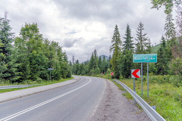 Asphalt road entering Koscielisko village in Poland