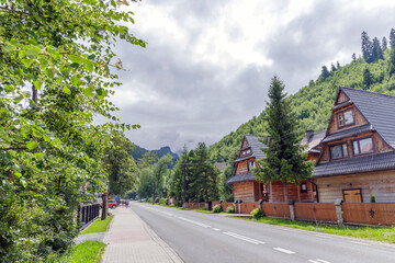 Scenic street with traditional houses in Koscielisko