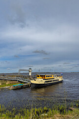 Fototapeta premium Ferry boat docking at a pier on a lake