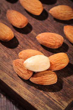 Mixed Almond Nuts with Original Baked Salt Flavors on Wooden Board - Healthy Snack Variety