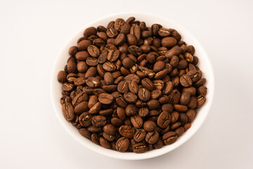 Obraz premium Coffee beans on a white background. Top view. Coffee beans texture.