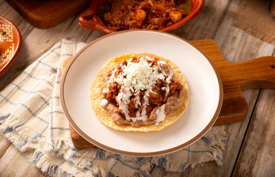 Tinga toast, a traditional Mexican home-cooked dish consisting primarily of beef cooked with chipotle chili and lots of onion, is traditionally eaten on "Tostadas" (fried corn tortillas).