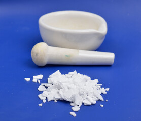 Potassium hydroxide KOH, and is commonly called caustic potash.