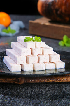 Fresh Taro Cubes from Guangxi Province China Arranged on Slate Board with Mint Garnish Traditional Asian Cooking Ingredient