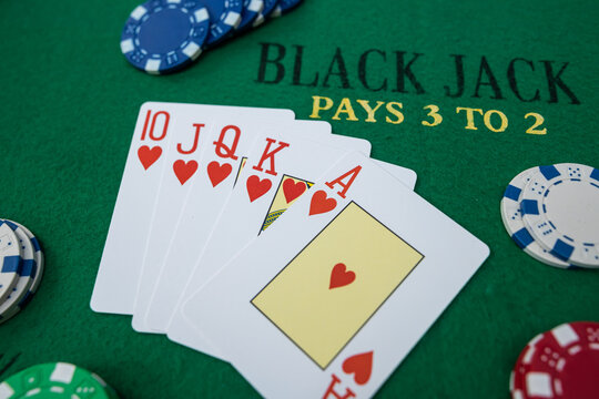 Winning poker straight combination with playing cards and chips on green table