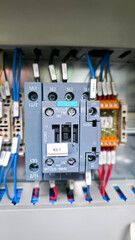 Close-up photo of an electrical contactor inside a control cabinet with connected wiring. The image highlights industrial automation, power switching, and reliable electrical control systems.
