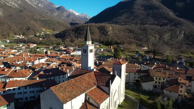 Cinematic Dolly Zoom of Venzone Cathedral: Drone Pull Back Reveal, Historic Duomo di Sant Andrea Cathedral Framed by Two Alpine Mountains, Friuli Italy 4K Video