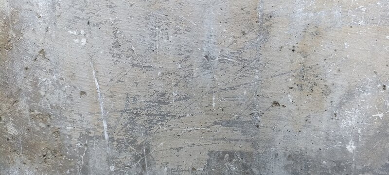 Scratched Gray Concrete Surface Texture with Random Marks. Gray concrete surface filled with scratches and random marks, creating a raw industrial abstract background