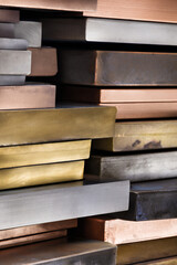 stacked metal sheets of aluminum copper zinc lead and alloys, closeup of clean industrial metal panels, textured metallic layers for construction materials