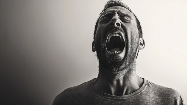 Black and white photo of a man screaming.