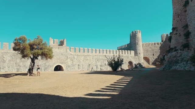 Medieval fortress architecture: The historic walls and towers of Mamure Kalesi under a blue sky