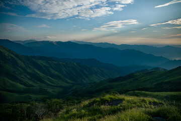 Alpine Mountain Valley with Layered Peaks and Green Meadow