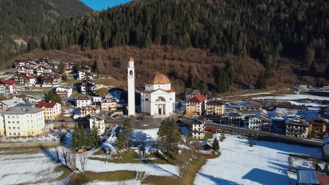 4K Aerial Reveal of Auronzo di Cadore: Drone Flyover from Santa Giustina Church to Santa Caterina Lake, Dolomites Mountain Landscape, Cortina Region Italy
