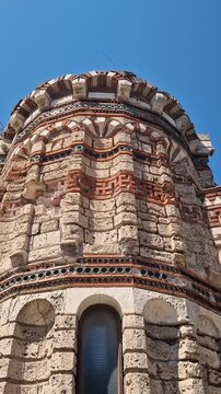 Nessebar, Bulgaria - August 25, 2025: Church of Christ Pantocrator. Fragment of the facade of a medieval Orthodox church. Late Byzantine style. Facade with colorful decor, ceramic elements