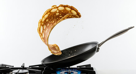 cooking pancakes on a gas stove in the kitchen