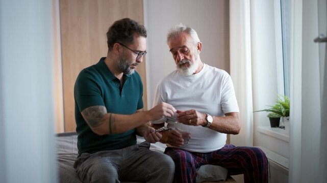 Son supporting father after surgery, helping him to recover.