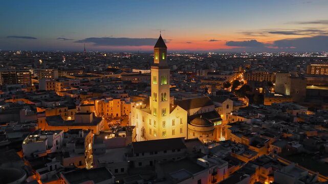 Aerial view of Bari Cathedral San Sabino in Bari old town, Apulia, Italy. Bari city glows with evening lights in southern Italy